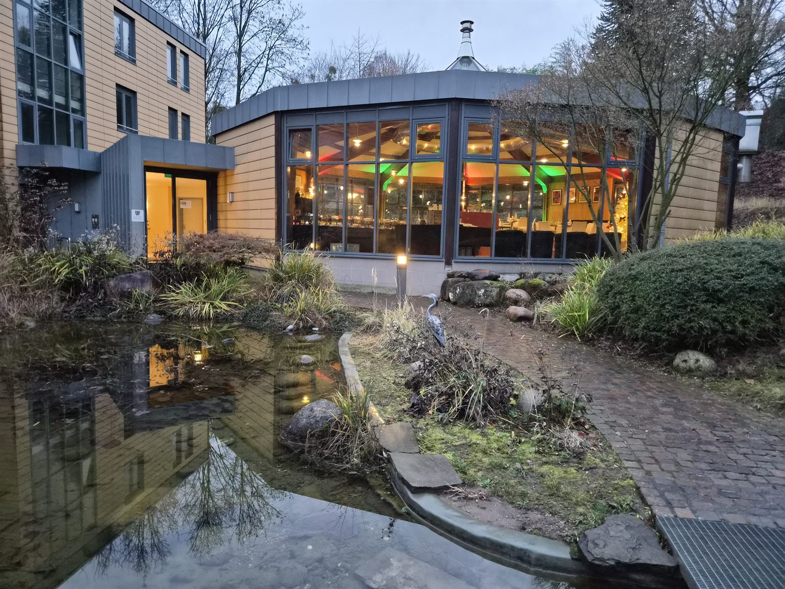 Die Rotunde am Abend von außen mit warm erleuchteten Fenstern